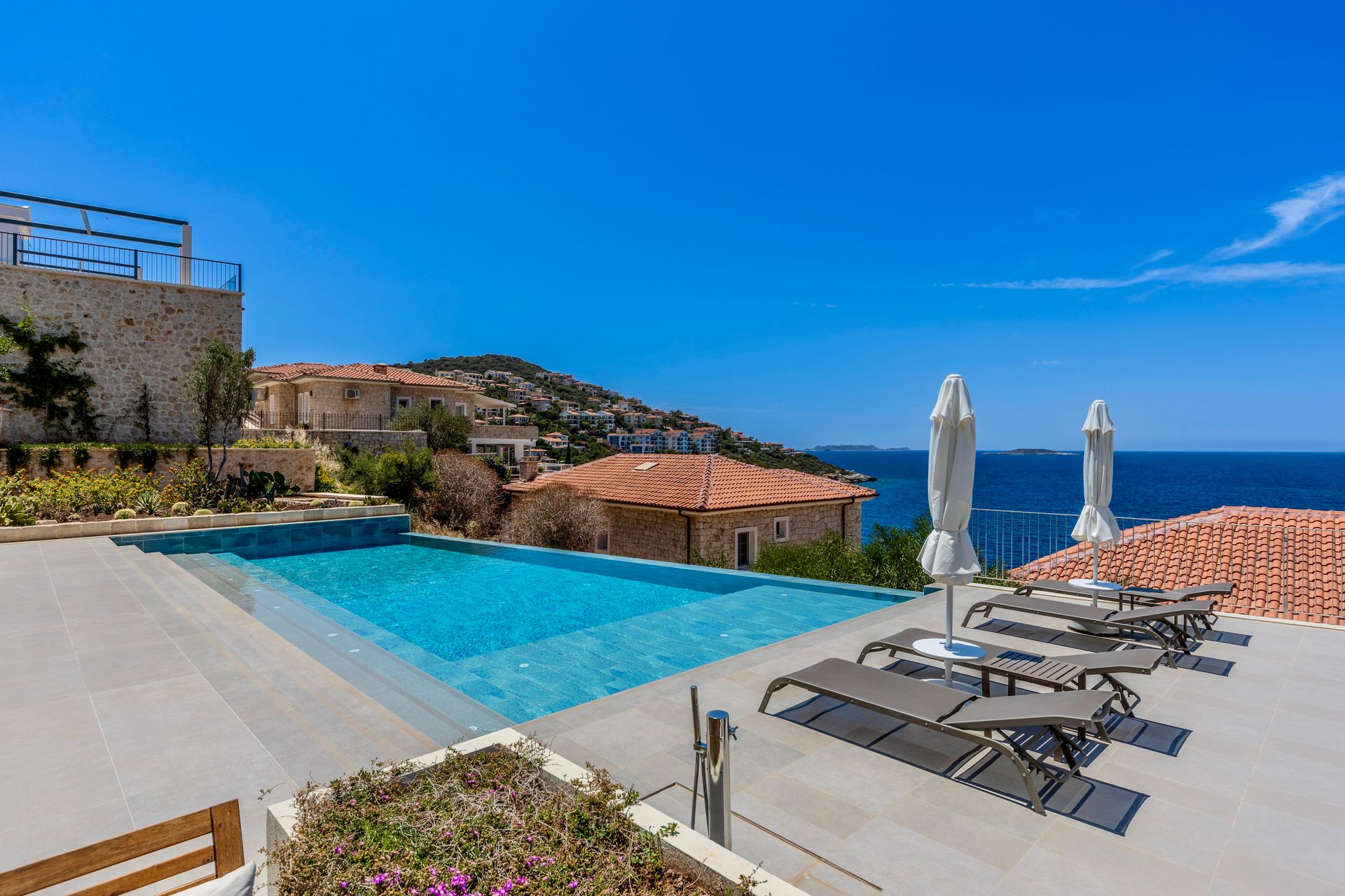 A Mediterranean villa terrace with an infinity pool